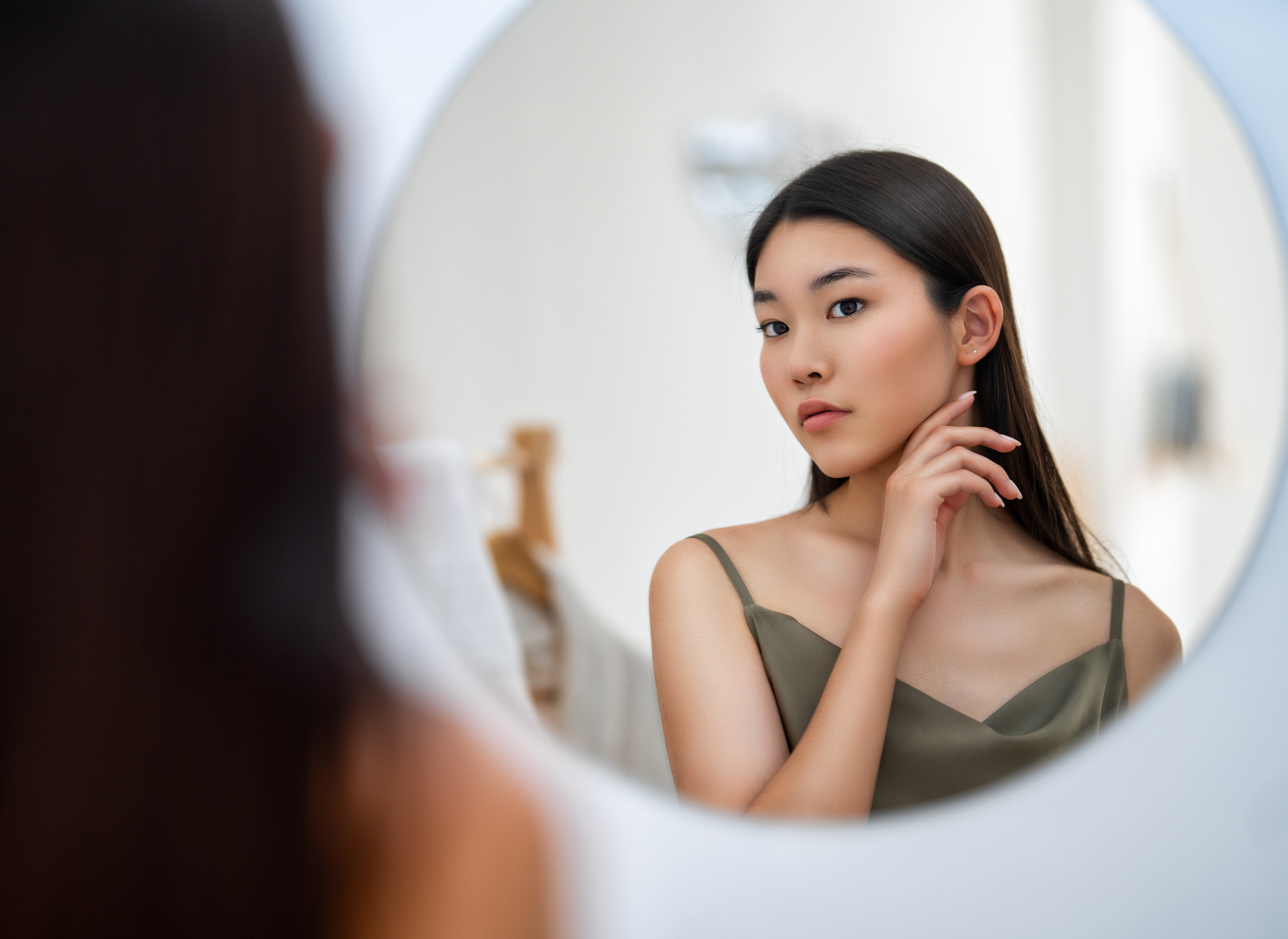 woman looking at mirror