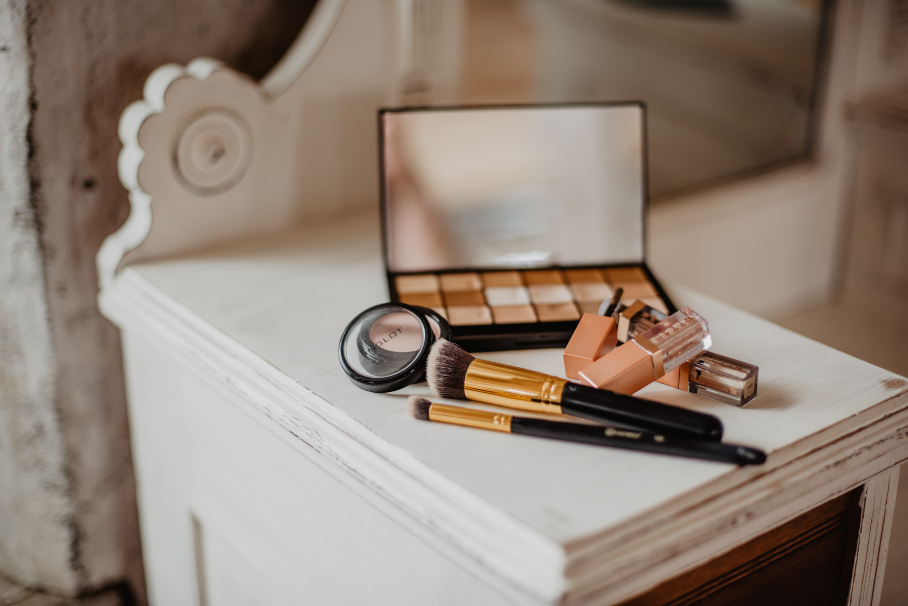 Make-up Brushes and Make-up Palette on Table